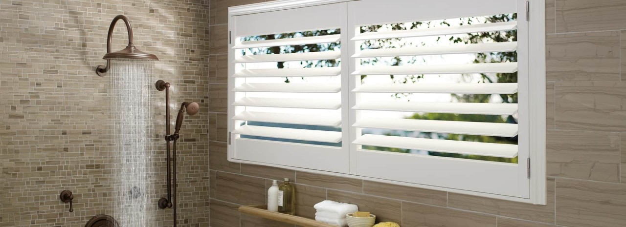 Hunter Douglas bathroom window treatments, Duette® Honeycomb Shades, Palm Beach™ Polysatin™ Shutters near Cape Coral (FL).